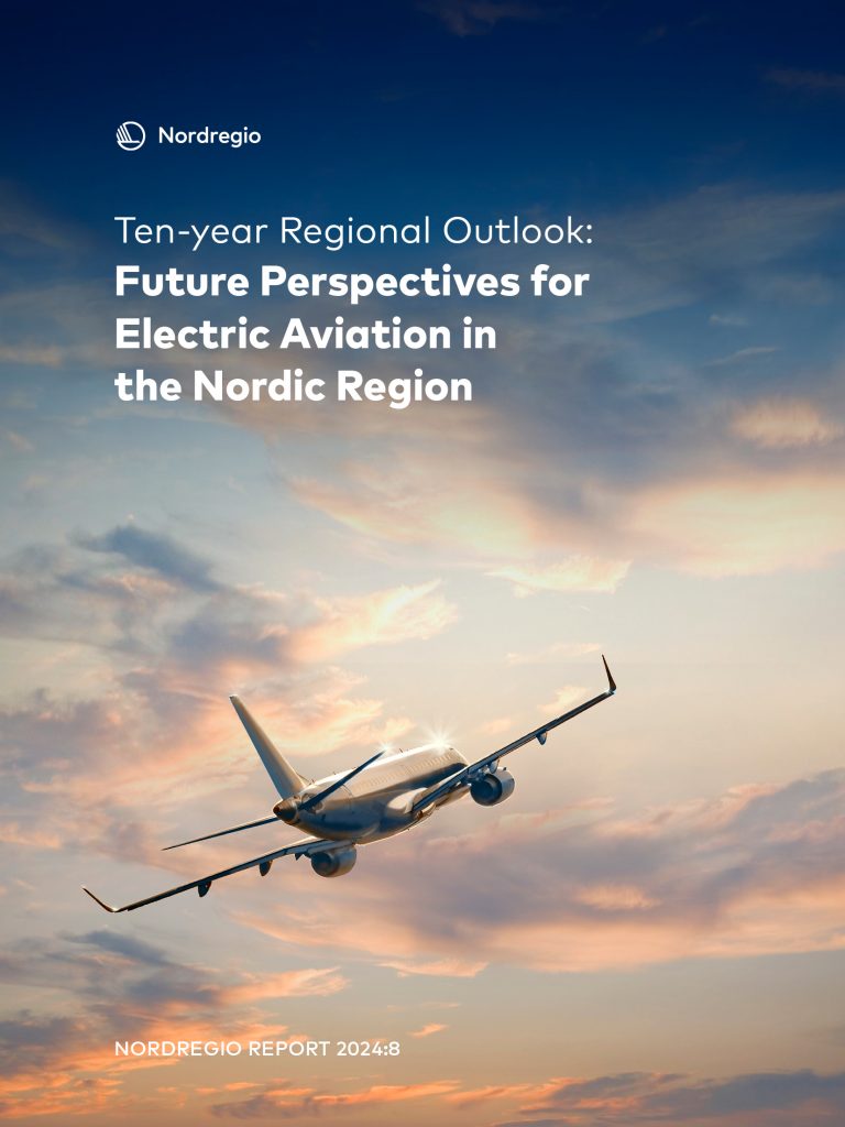 airplane flying on the sky with clouds coloured by sunset on the background