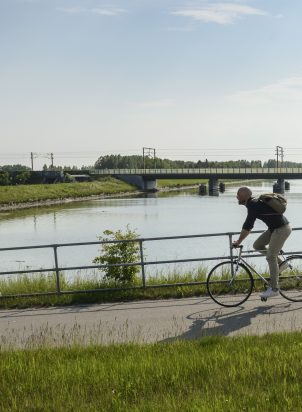 Cyclist on the bike network alongside water in Denmark