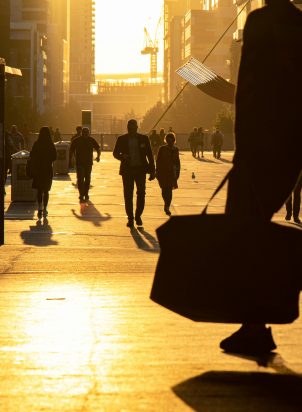 People on the move in a city during golden hour