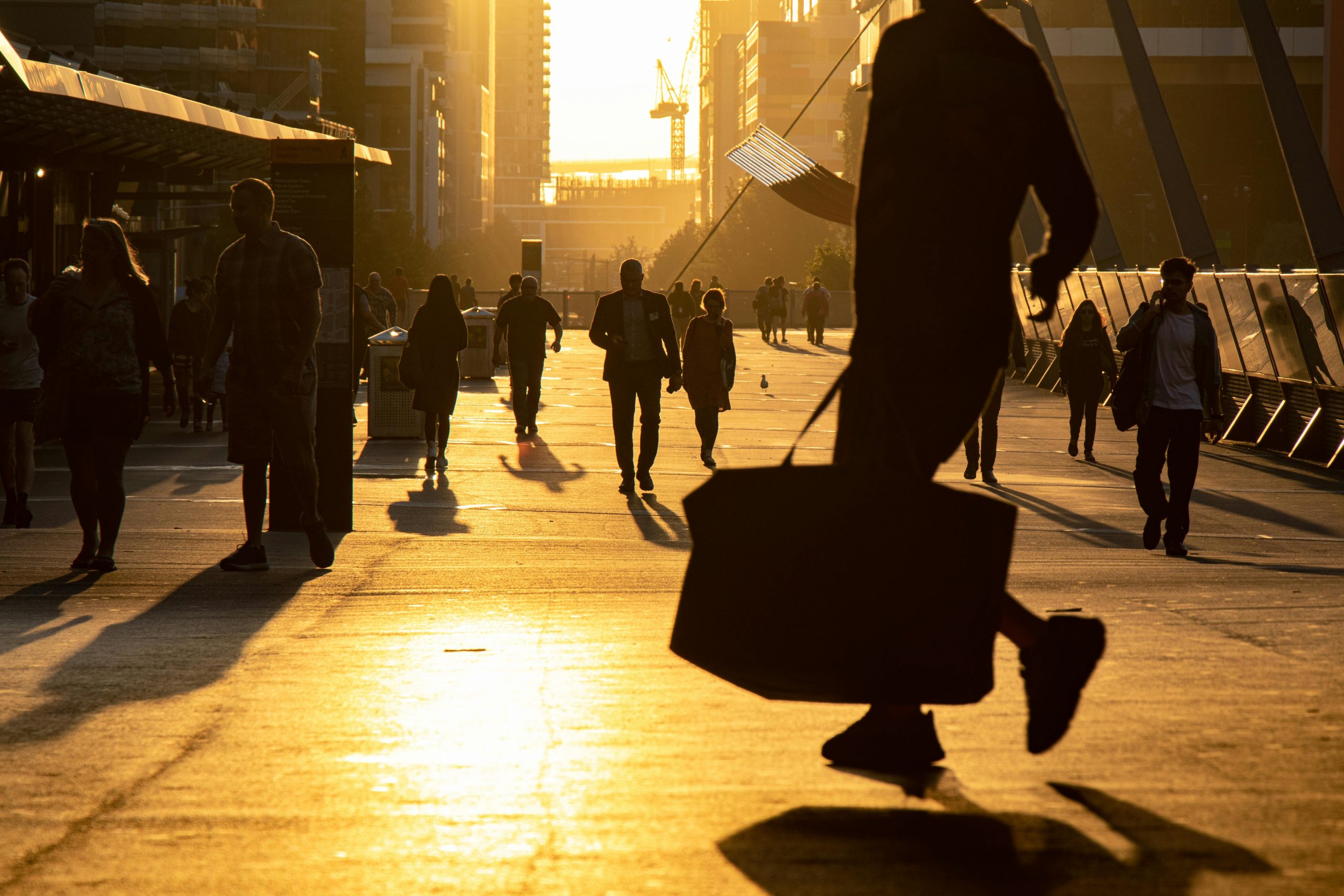 People on the move in a city during golden hour
