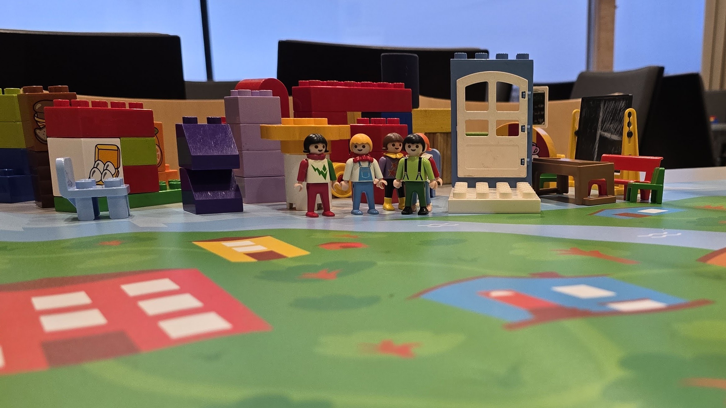 toy figurines and duplo blocks set up on a table