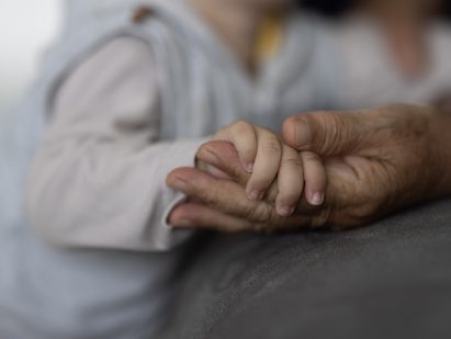 young and old person holding hands, close-up of hands
