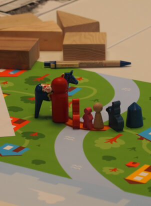 wooden blocks and play characters on a game board